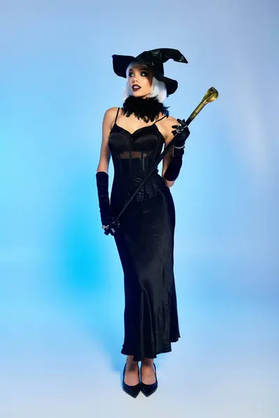 Dressed as a witch, the beautiful woman showcases her enchanting costume with flair. — Stock Photo