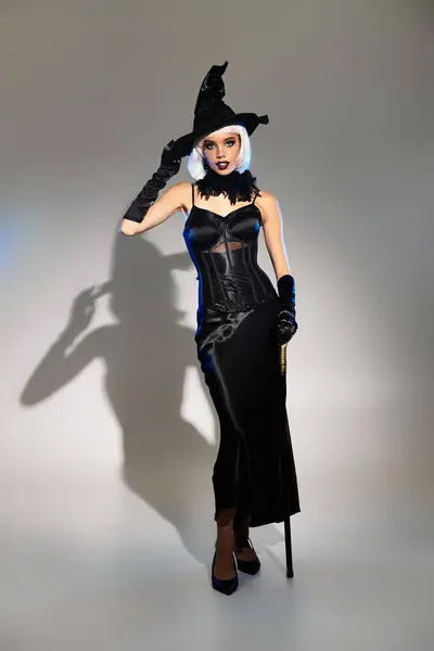This young woman dazzles in a stunning Halloween witch costume, radiating charm. — Stock Photo