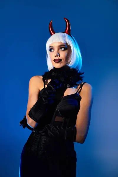 A beautiful young woman showcases her Halloween costume with striking elegance and flair. — Stock Photo