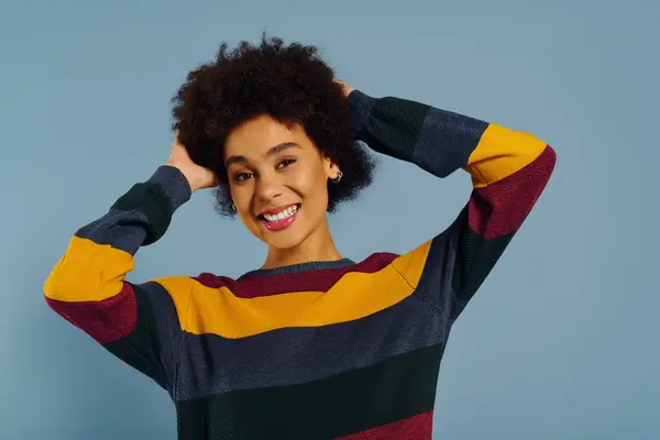 A young woman with curly hair joyfully poses, displaying her vibrant personality and playful spirit. — Stock Photo