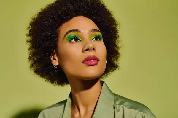 With vibrant makeup and a thoughtful expression, a young woman connects with her emotions. — Stock Photo