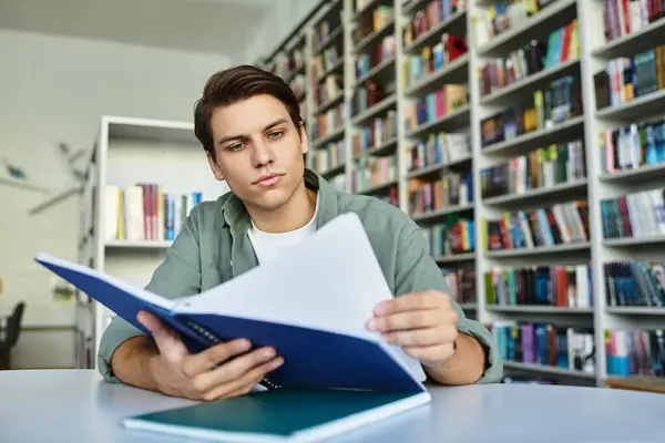 A focused student engages with study materials in a lively, inviting library. — Stock Photo