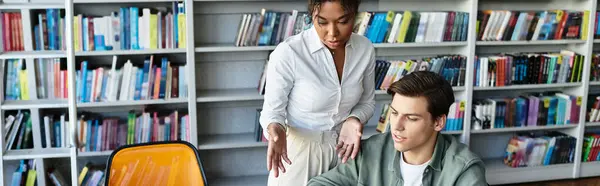 A devoted teacher helps her student grasp new concepts among books. — Stock Photo