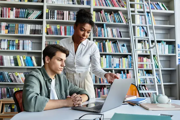 A talented teacher assists her young student with homework in a cozy library environment. — Stock Photo