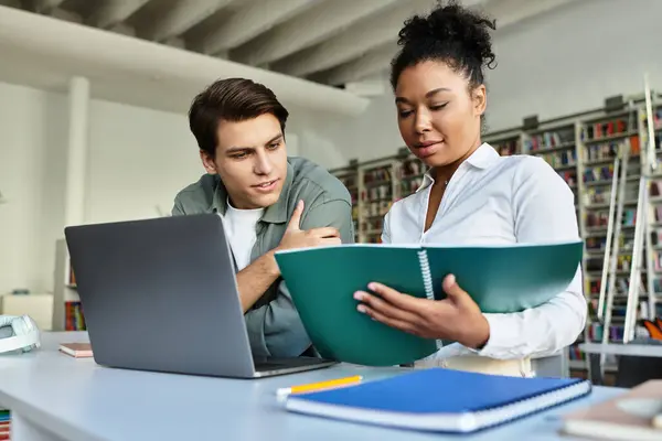 A dedicated educator assists her young student with important study concepts in a lively classroom. — Stock Photo