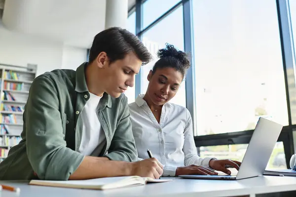 A beautiful teacher guides her young student in learning during an interactive session. — Stock Photo