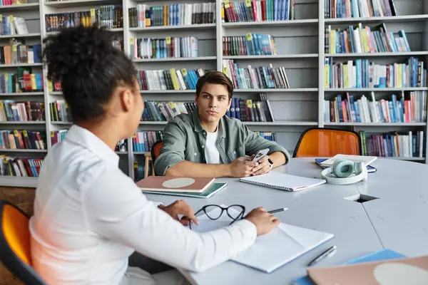 A dedicated teacher engages her student in an inspiring conversation about learning materials. — Stock Photo
