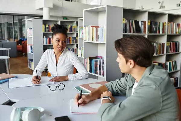 An inspiring educator engages a young learner in a productive study session. — Stock Photo