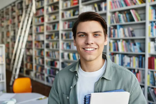 Cheerful young student at library, back to school. — Stock Photo