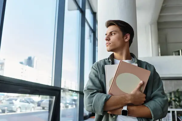Dedicated handsome student in casual attire at school, studying hard. — Stock Photo