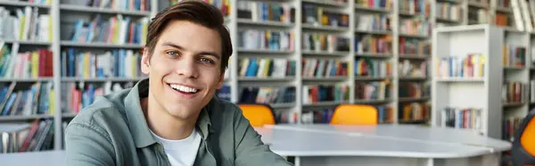 Positive handsome student in casual attire at school, studying hard. — Stock Photo