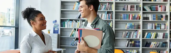A young student listens attentively as a teacher shares knowledge in an inviting library. — Stock Photo