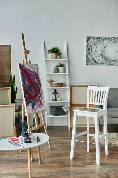 A cozy artist studio with a canvas easel and vibrant paints — Stock Photo