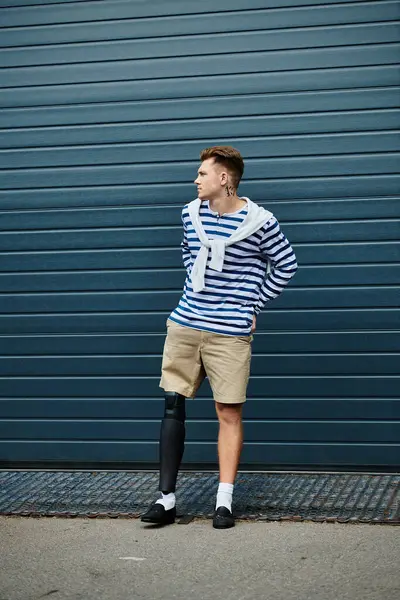 Confident young man stands tall, showcasing his stylish outfit and embracing his uniqueness. — Stock Photo
