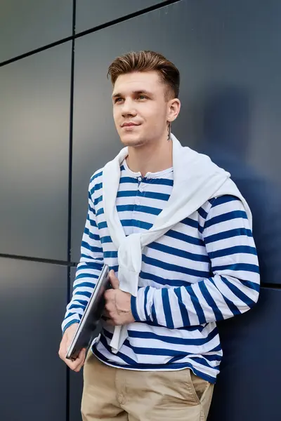 A young man with a prosthetic leg stands proudly against a wall, showcasing his style. — Stock Photo