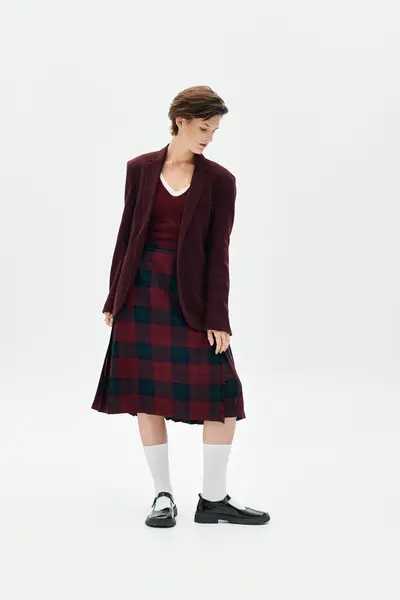 A woman dressed in elegant winter fashion showcases her cozy, sophisticated style indoors. — Stock Photo