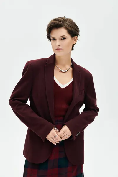 A woman exudes confidence in warm winter attire, blending elegance with comfort effortlessly. — Stock Photo