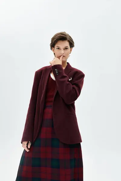 The woman embraces winter warmth and style in cozy yet chic attire, exuding confidence. — Stock Photo