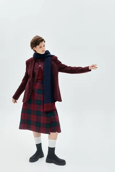 A graceful woman showcases cozy winter fashion with layered outfits and a playful pose. — Stock Photo