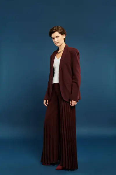 A beautiful woman showcases stylish winter fashion, exuding elegance and confidence indoors. — Stock Photo