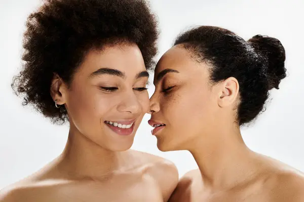 Two women share a tender moment, their faces close together, showcasing friendship and warmth. — Stock Photo