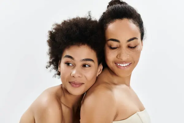 Two women stand together, radiating warmth and embodying true friendship. — Stock Photo