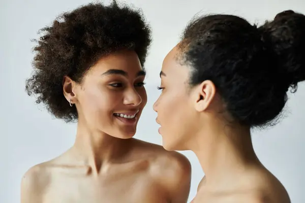 Two individuals share an intimate moment, highlighting their joyful expressions and connection. — Stock Photo