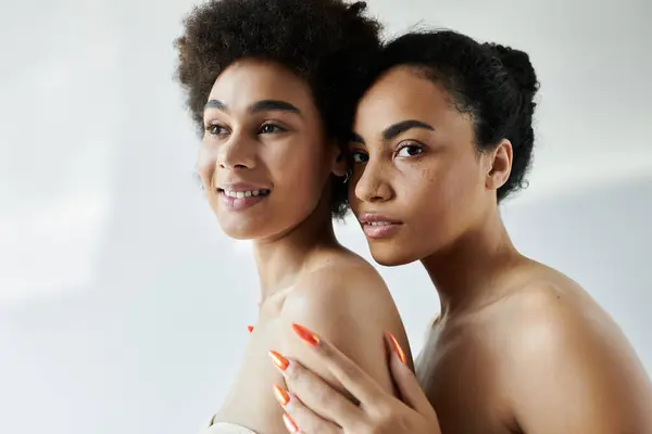 Two women stand close, showcasing confidence and elegance in a delicate atmosphere. — Stock Photo