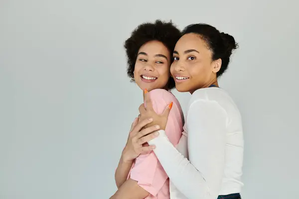 Two women share a lighthearted moment together, showcasing their connection and happiness. — Stock Photo