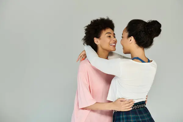 Zwei Freunde teilen einen freudigen Moment und drücken in ihren gemütlichen Outfits Freundschaft und Wärme aus. — Stockfoto