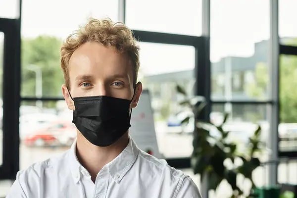 A dedicated redhead businessman in a white shirt in a stylish office space. — Stock Photo