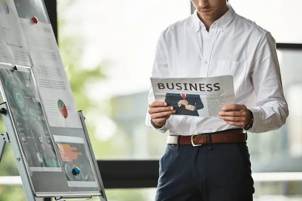 The redhead businessman studies his project material intently in a sleek office environment. — Stock Photo