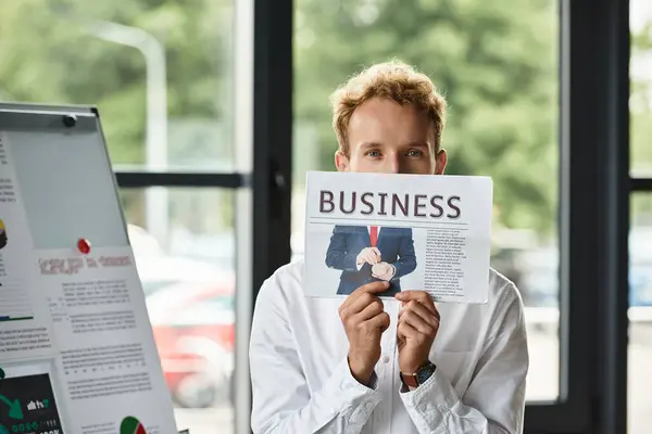 A dedicated redhead businessman wearing a white shirt showcases creative project concepts in his office. — Stock Photo