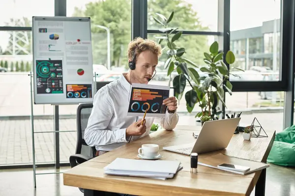 A dedicated businessman analyzes project data while working from a stylish, contemporary office environment. — Stock Photo