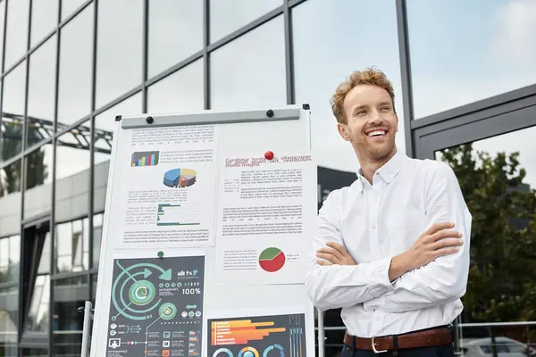 The redhead professional shares his project insights with enthusiasm in a sleek office setting. — Stock Photo