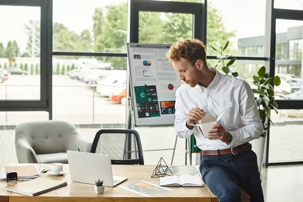 A focused redhead professional in a white shirt develops project strategies in a stylish office space. — Stock Photo