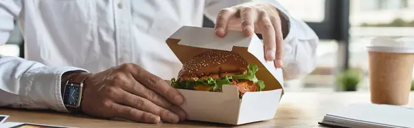 A cropped professional in a white shirt focuses on his work while savoring a delicious lunch in the office. — Stock Photo