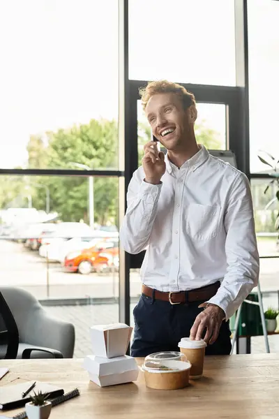 A focused businessman engages in a lively discussion while working in a sleek office setting. — Stock Photo