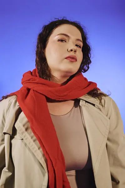 A beautiful plus size woman confidently poses, adorned in a stylish outfit with a bold red scarf. — Stock Photo