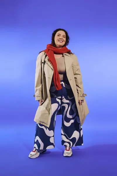 In piedi con fiducia, un plus size donna paia eleganti pantaloni gamba larga con un trench chic. — Foto stock