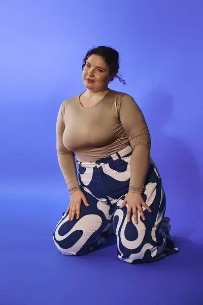 The beautiful plus size woman kneels elegantly, showcasing her confidence and unique fashion sense. — Stock Photo