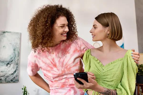Two young women share smiles and laughter while spending quality time together at home. — Stock Photo