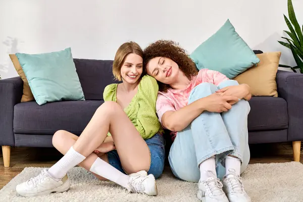 Two happy young women share laughter and warmth while relaxing on the floor. — Stock Photo