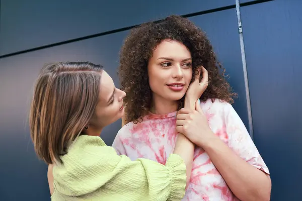 Two young women enjoy a joyful moment together, radiating love and happiness in a sunny setting. — Stock Photo
