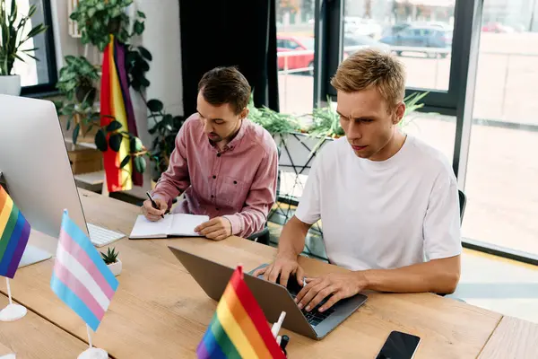 A handsome gay couple collaborates in an inspiring office, showcasing their creative energy. — Stock Photo