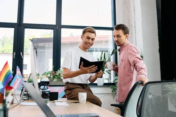 A cheerful couple discusses a project in a vibrant and welcoming workspace adorned with plants. — Stock Photo