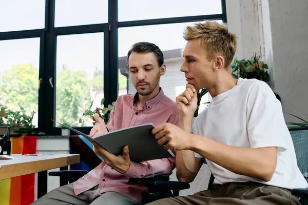 A charming couple discusses their innovative project while collaborating together. — Stock Photo