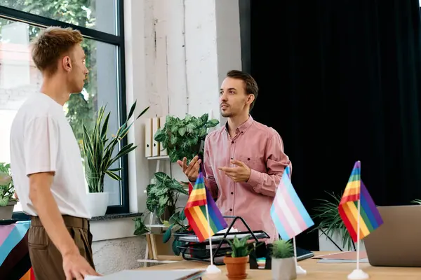 Two stylish men engaged in an animated conversation, celebrating love and inclusion. — Stock Photo