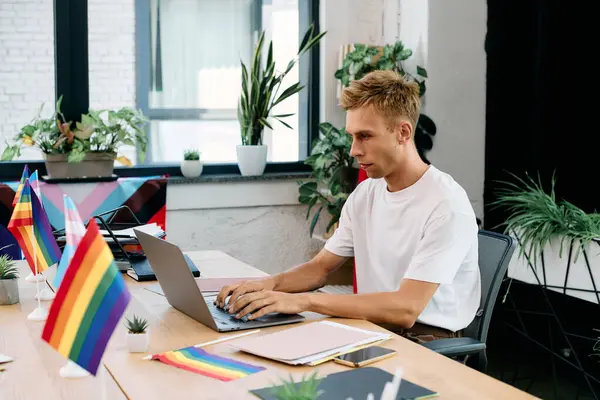 Young blonde man in casual attire working in office. — Stock Photo