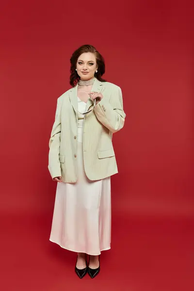 A young woman radiates elegance in a chic suit and dress combination, posing confidently. — Stock Photo